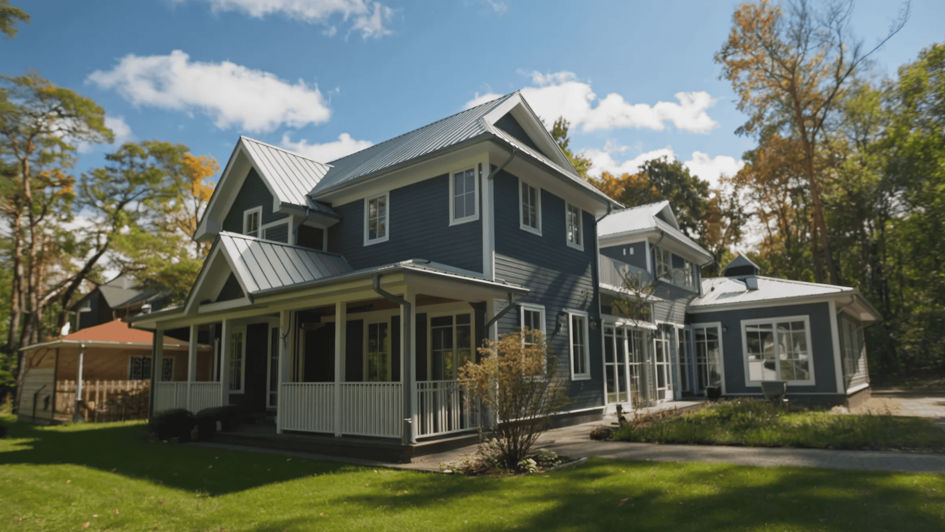 A blue house with a white roof, complete with a cozy porch