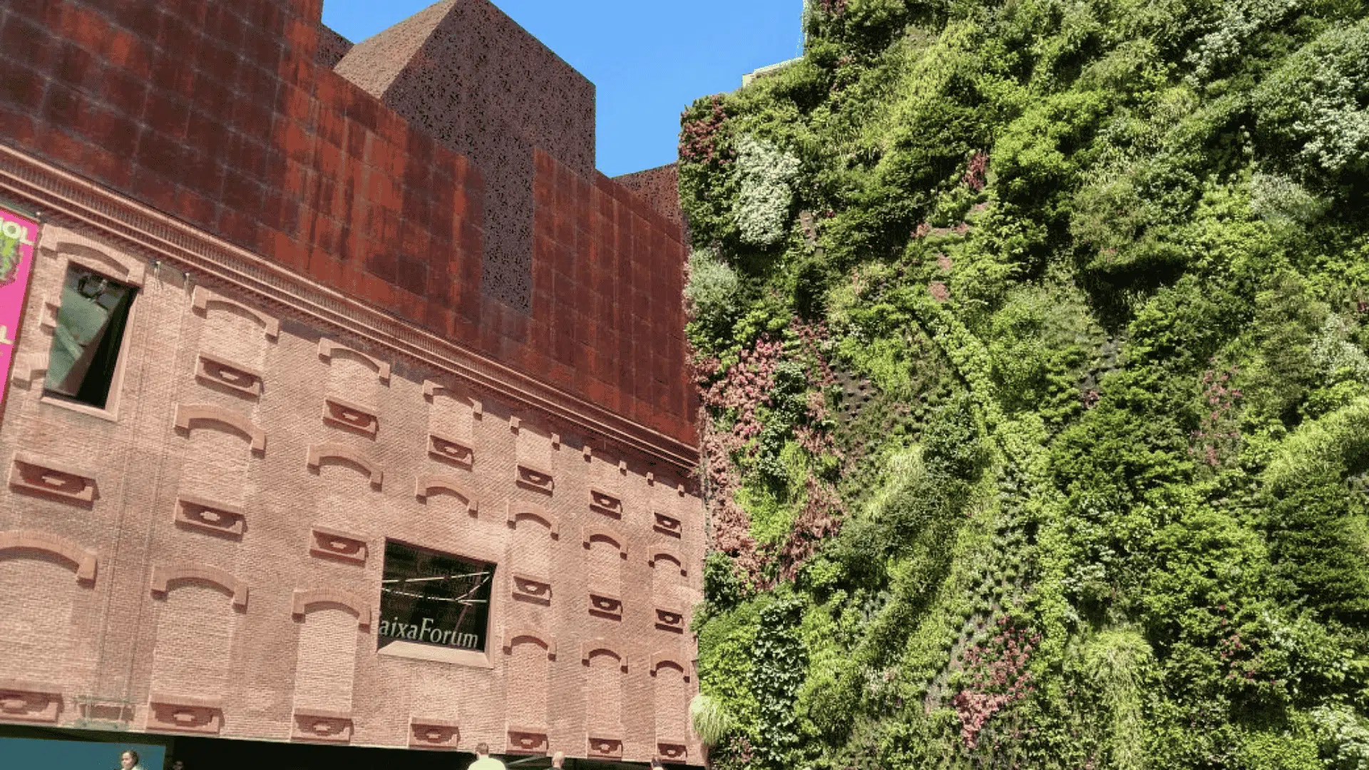 A building featuring a vibrant green wall, enhancing its eco-friendly design and blending with the surrounding nature