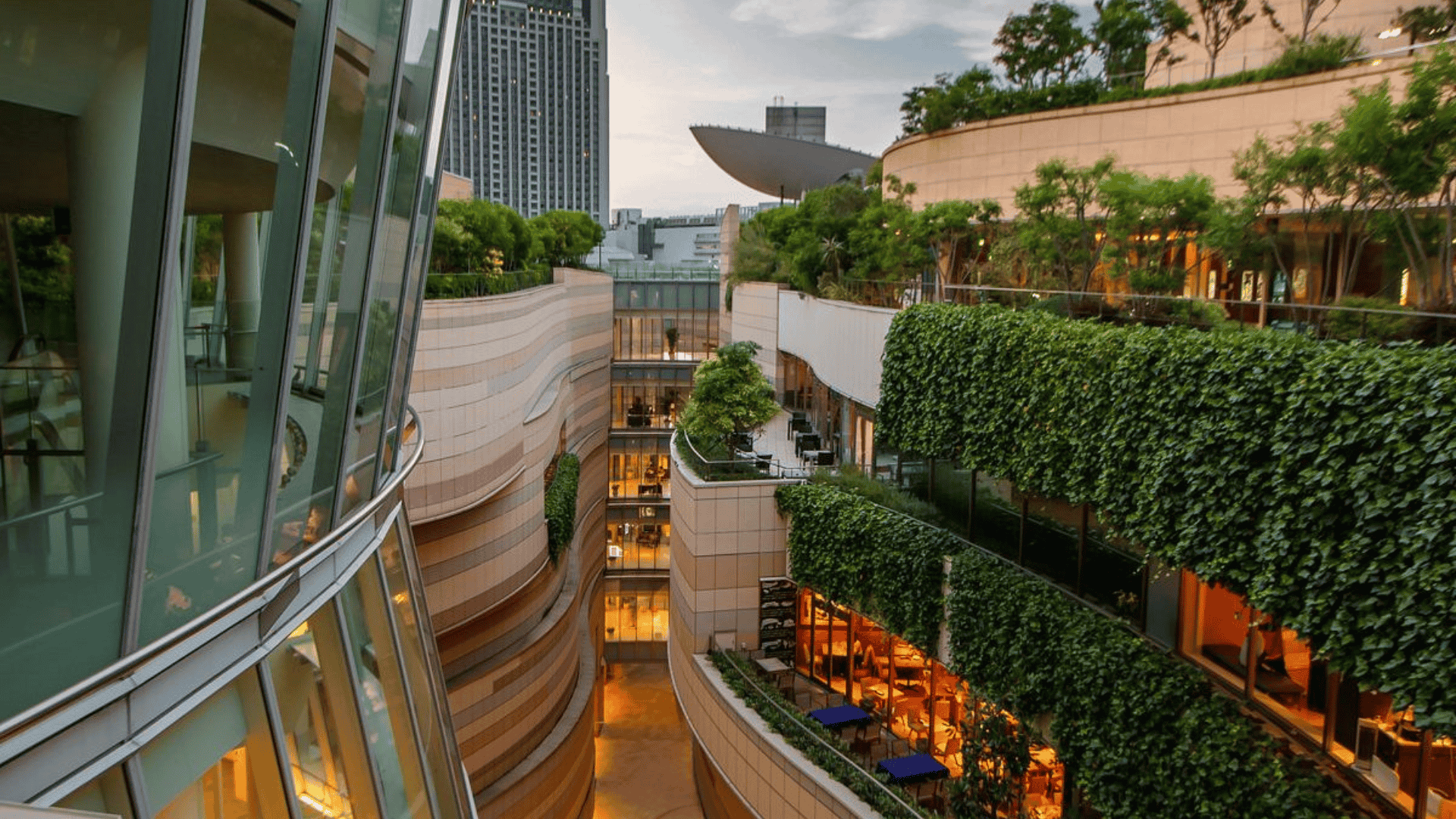 A contemporary structure with a lush green wall and a transparent glass wall, highlighting eco-friendly design elements
