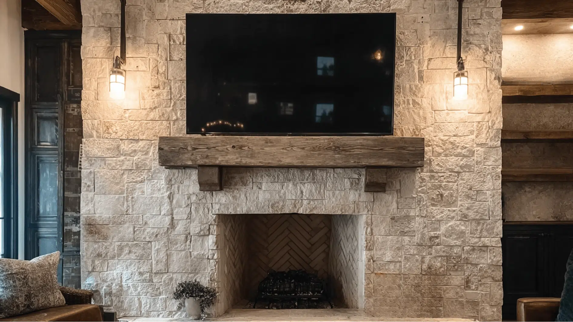 A living room scene highlighting a stone fireplace with a TV mounted above, blending rustic charm with modern entertainment
