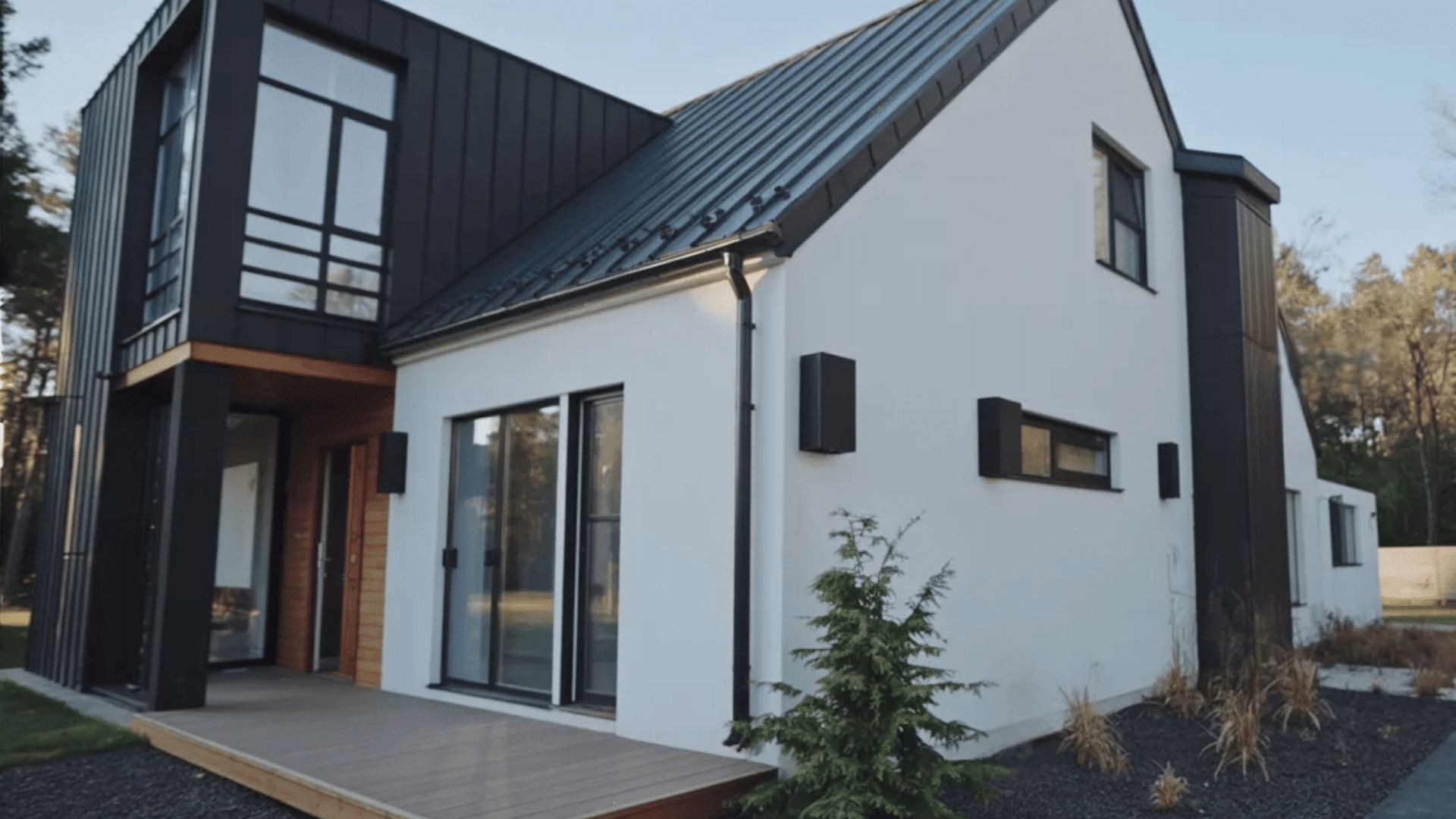 A modern house featuring a striking black and white exterior design, showcasing clean lines and contemporary architecture