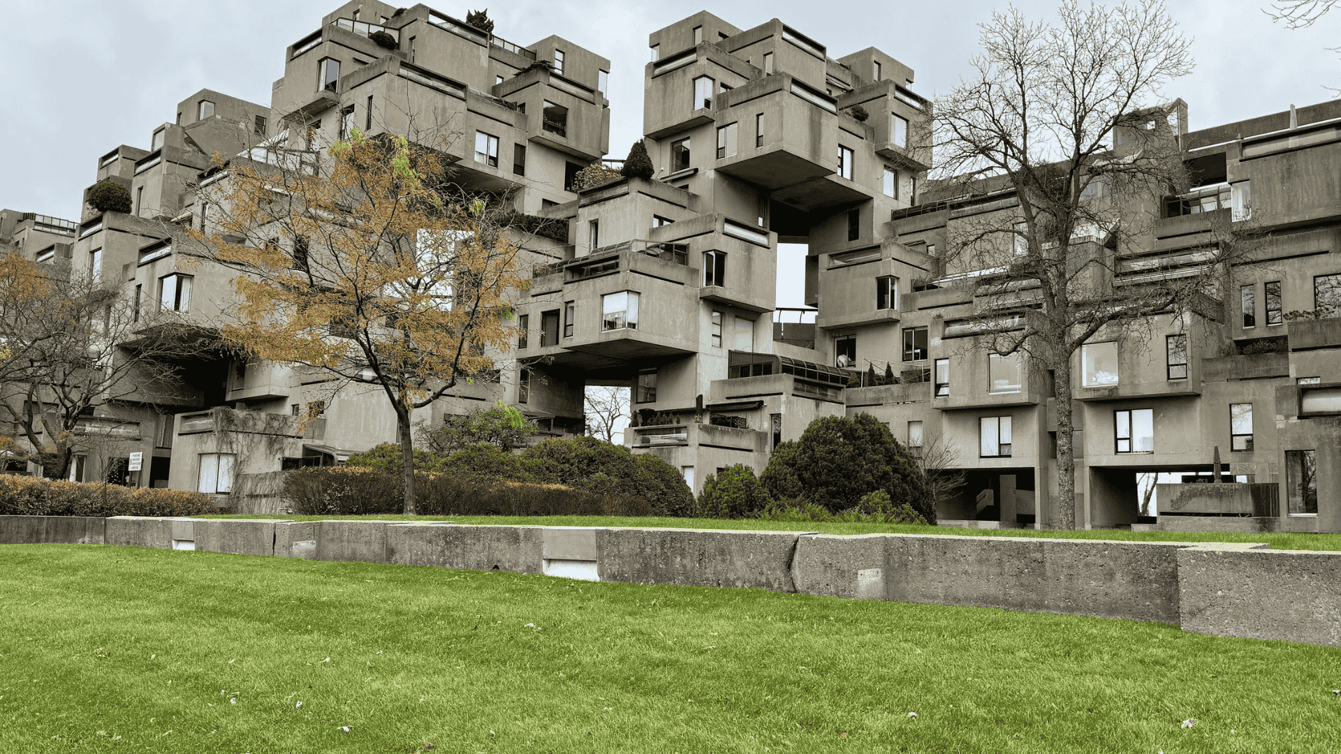 A multi-story building featuring several balconies on each floor, providing it a realistic view that has been placed under a clear sky