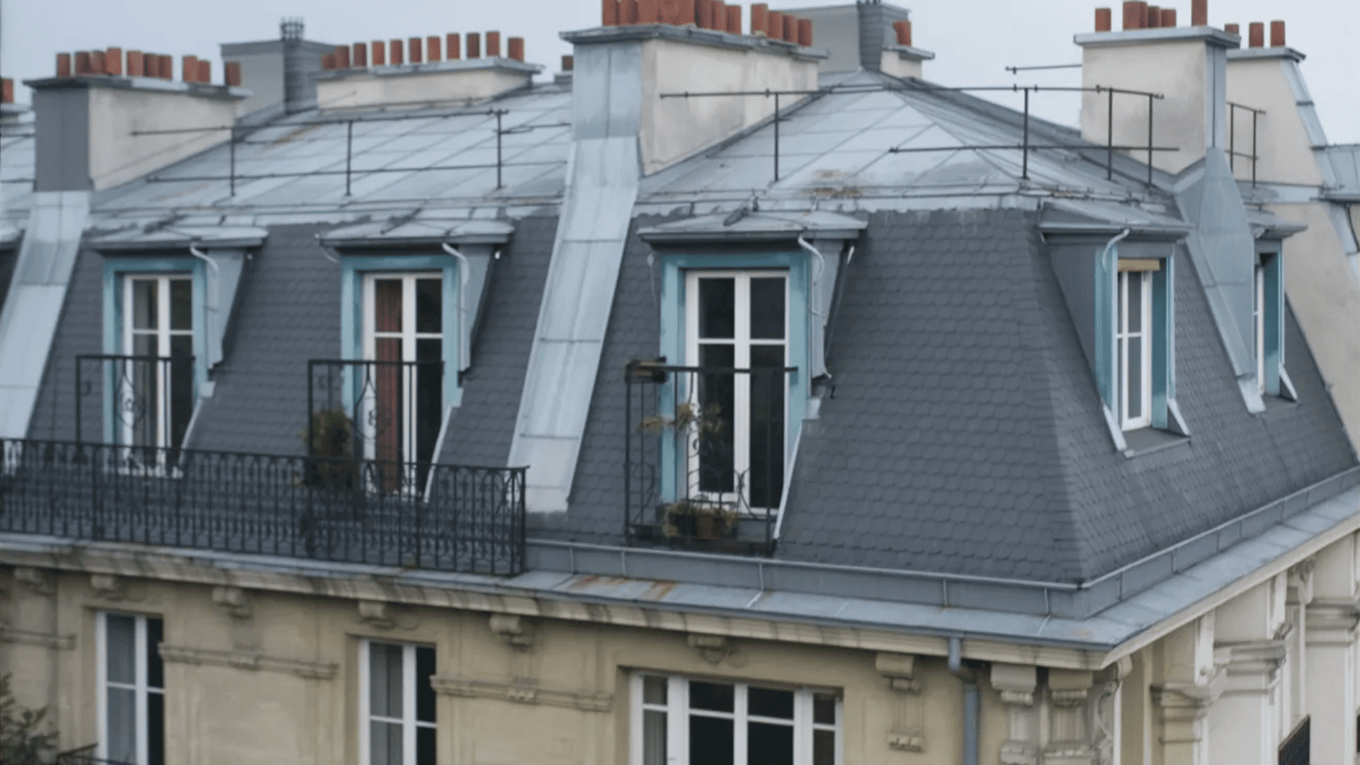 A roof featuring numerous windows and balconies, showcasing a modern architectural design