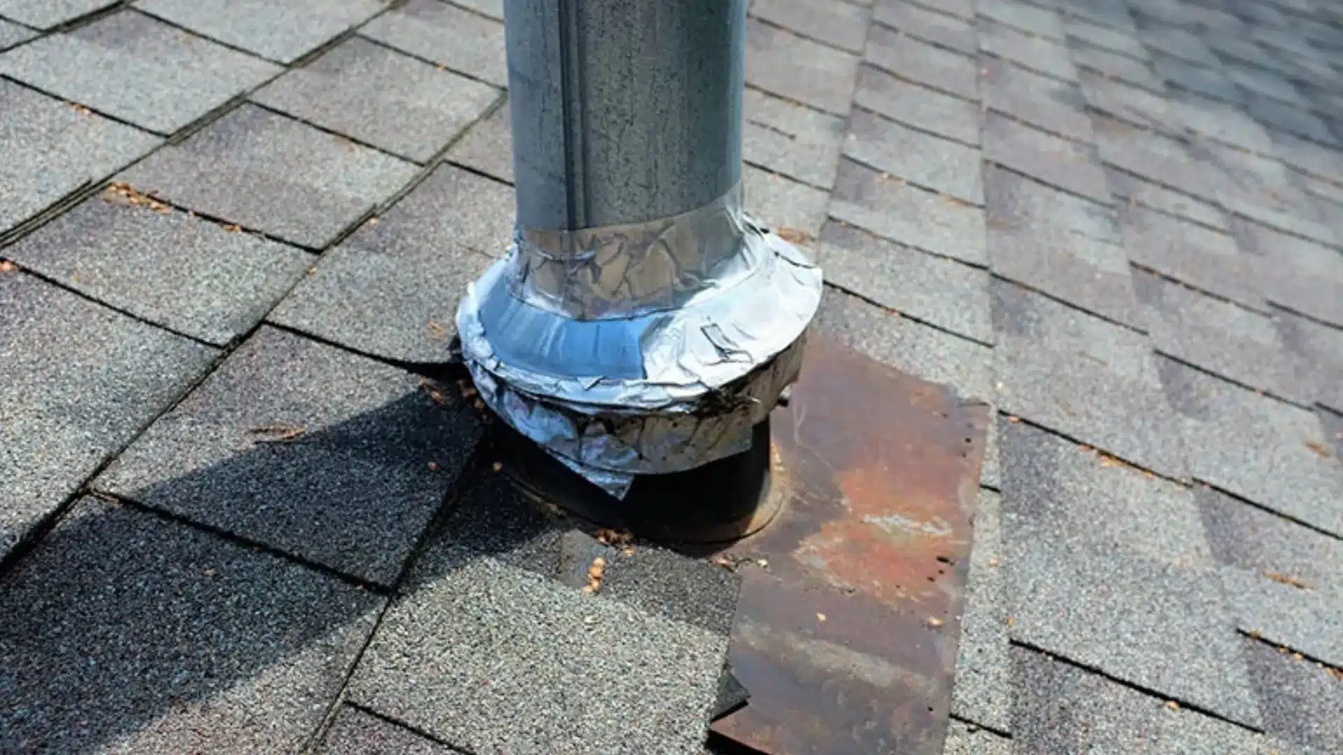 A metal pipe affixed to the roof highlights possible damage from flashing leaks