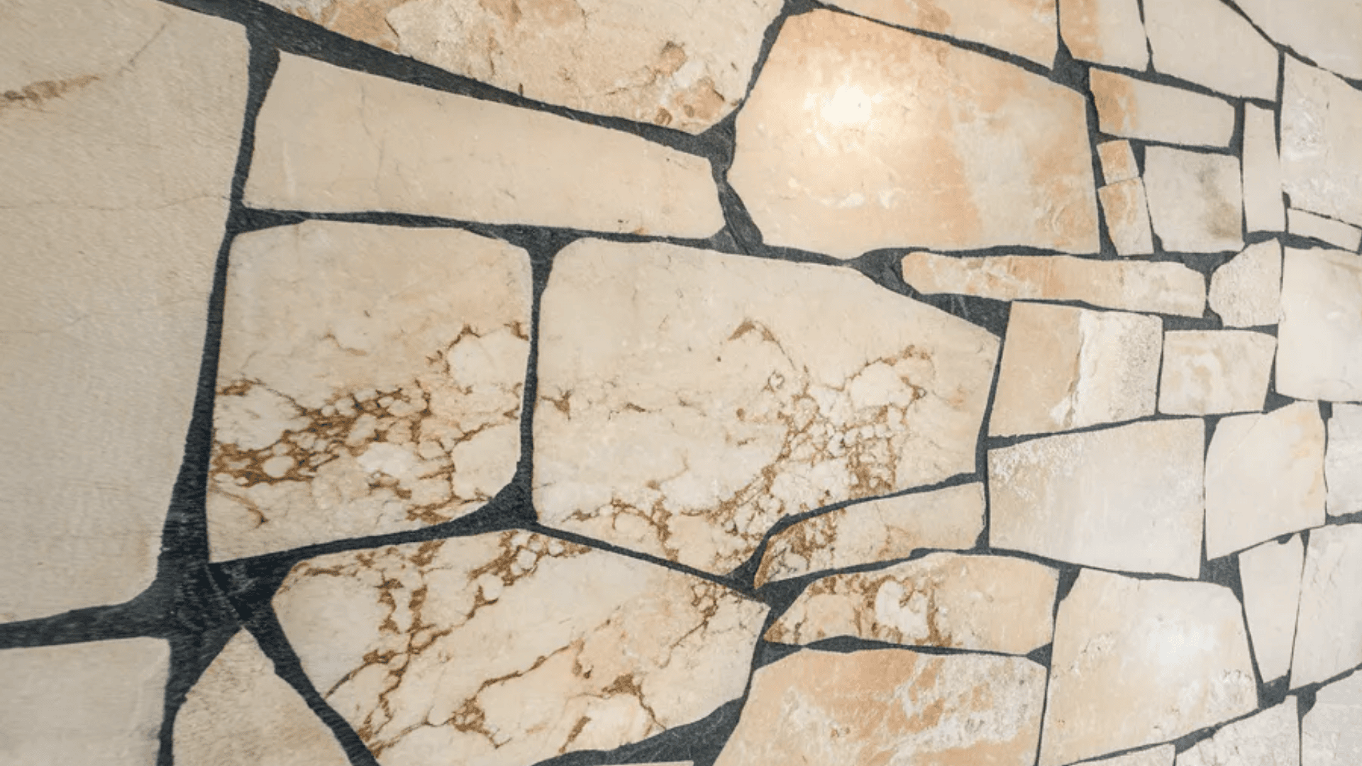 A close-up of a room's wall displaying a detailed stone pattern