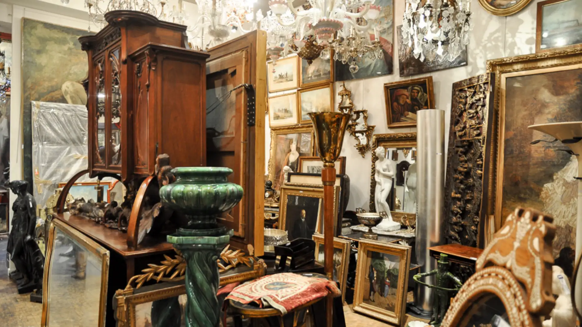 Antiques market at Place du Grand Sablon in Brussels with ornate furniture, chandeliers, paintings, and vintage decor displays