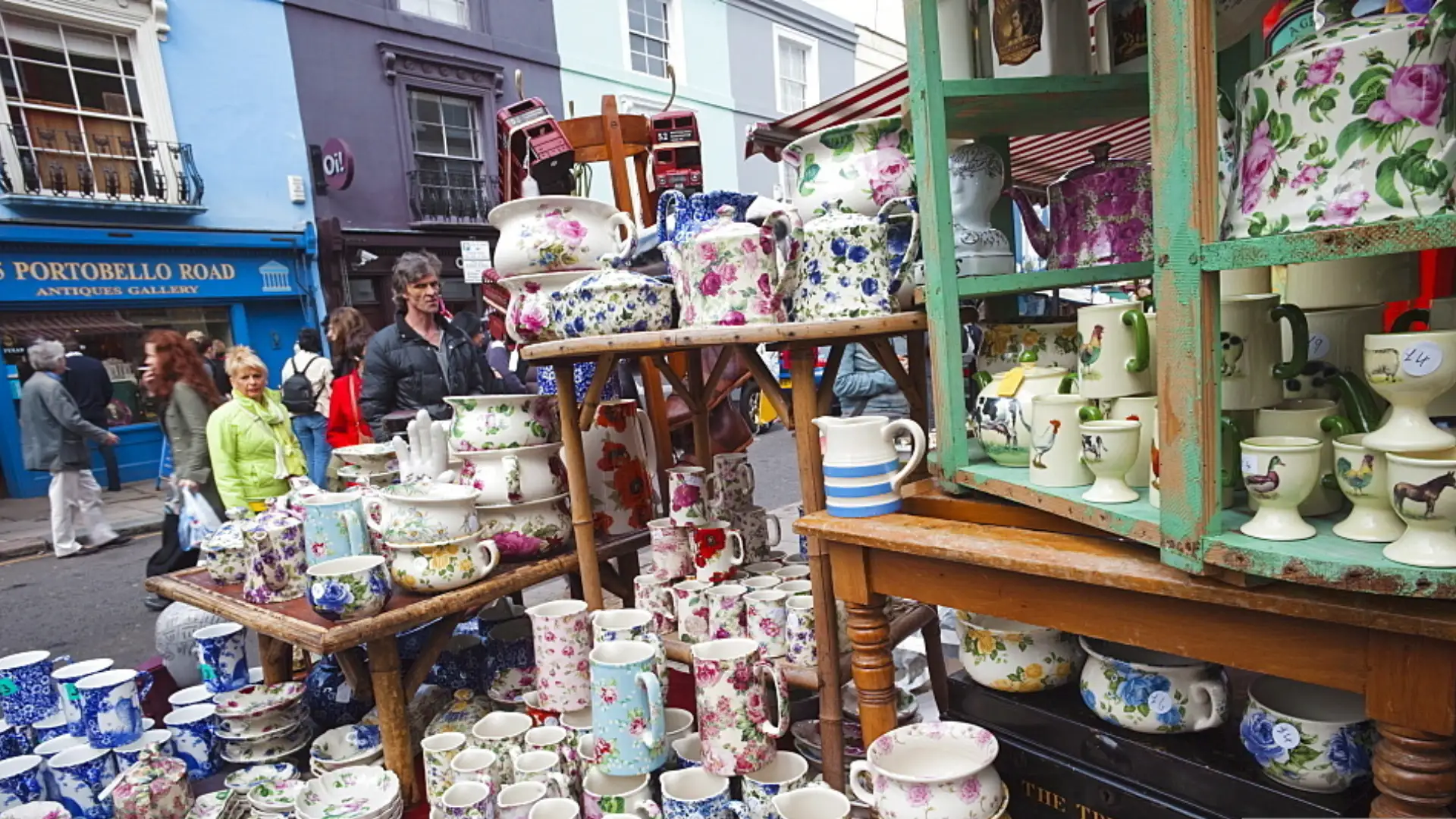 Busy Portobello Road Market with shoppers browsing under covered street stands