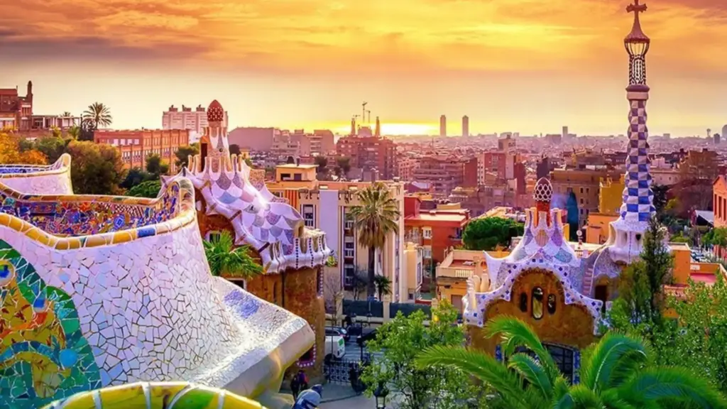 Which City in Spain Is Best Known for Architecture answer found in Park Guell mosaics at sunset with views of Barcelona