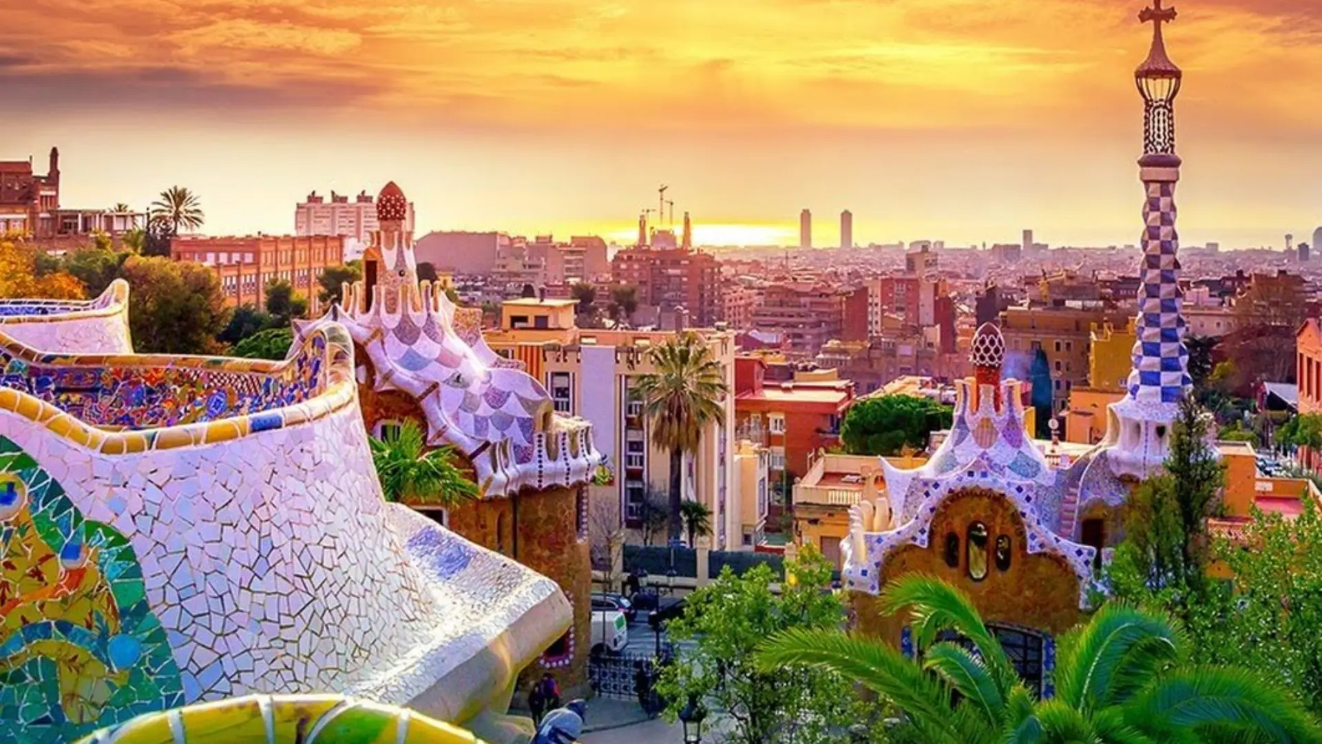 Which City in Spain Is Best Known for Architecture answer found in Park Guell mosaics at sunset with views of Barcelona