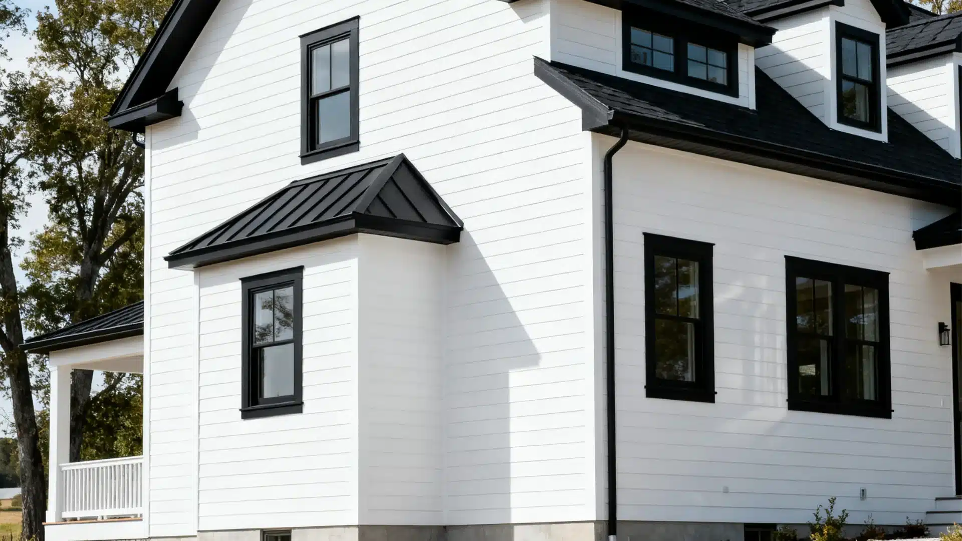 White farmhouse exterior with black trim, porch, and balanced facade creating a classic and clean modern look
