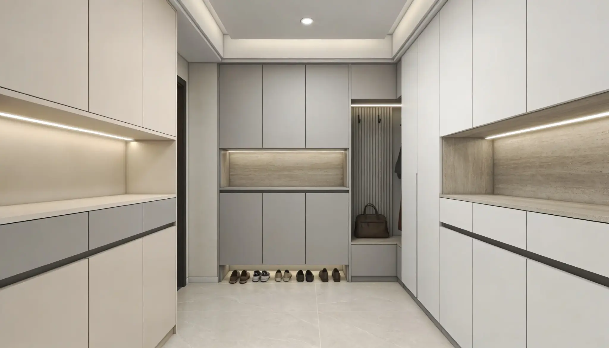 Modern minimalist entryway or mudroom featuring floor-to-ceiling light gray and white custom cabinetry with integrated LED accent lighting and a small shoe storage bench