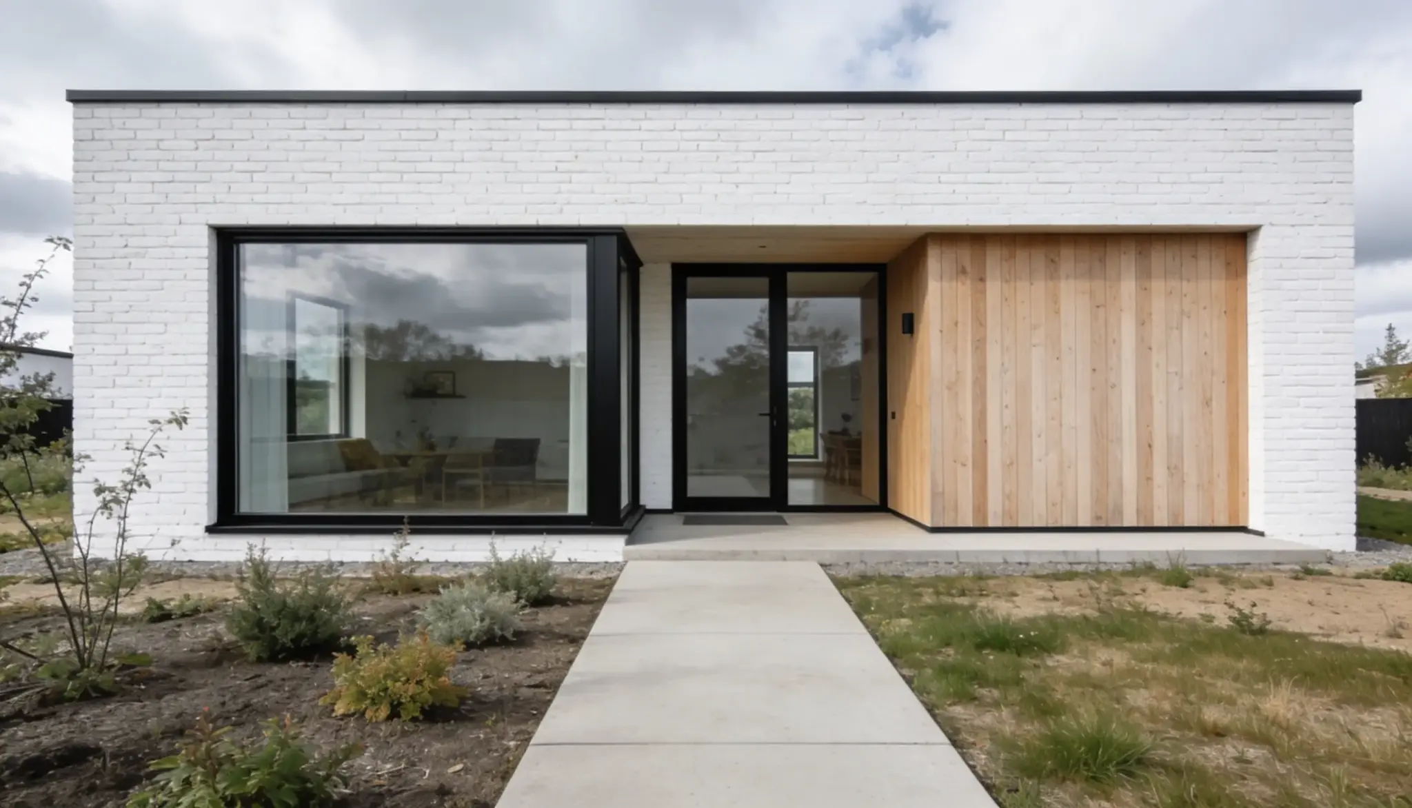 Modern minimalist home exterior featuring white painted brick, large black-framed windows, a glass entry door, and natural wood cladding