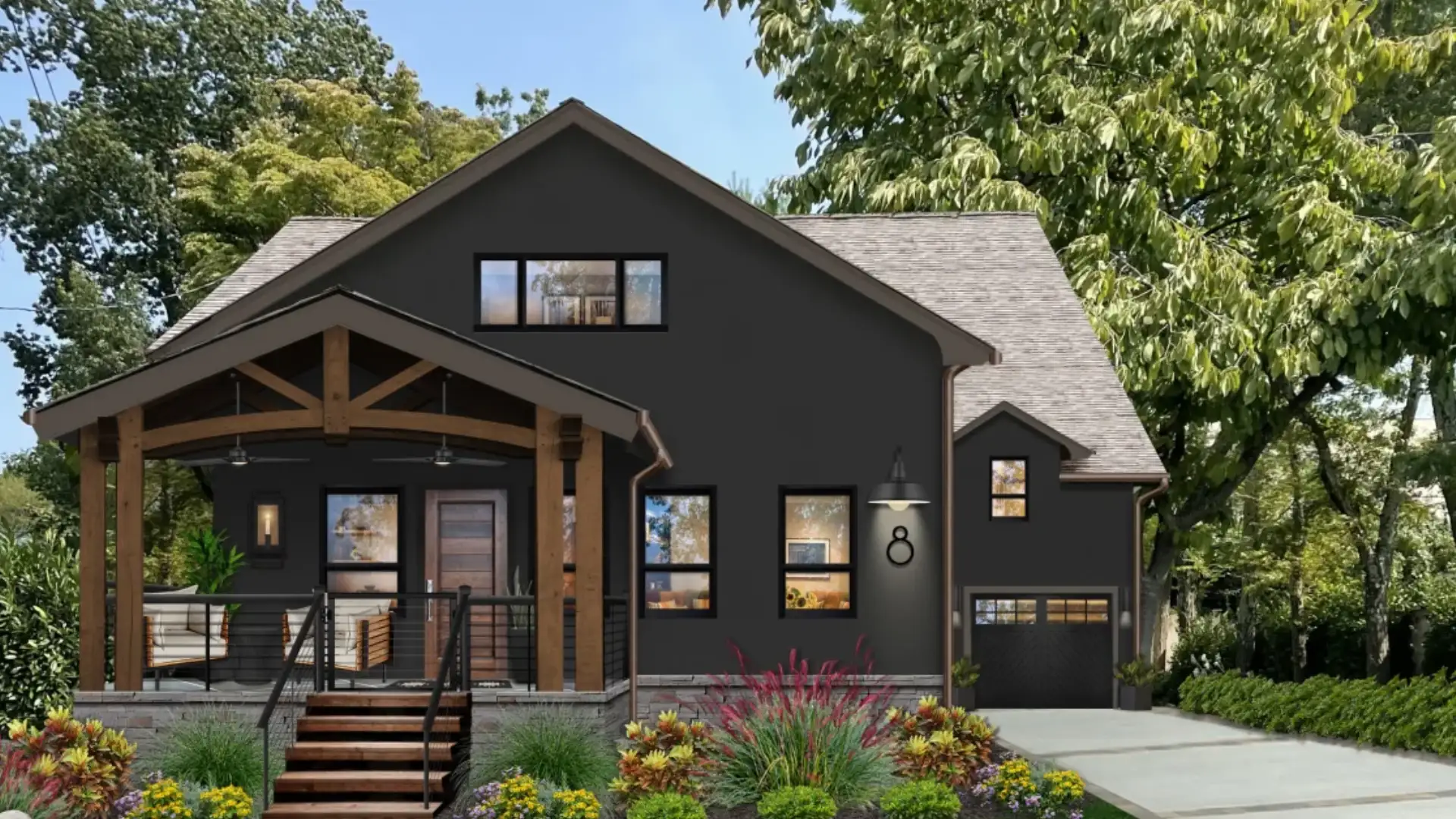 Modern dark-gray craftsman-style house with a covered wood-beam porch, landscaped garden, and attached garage surrounded by mature trees.