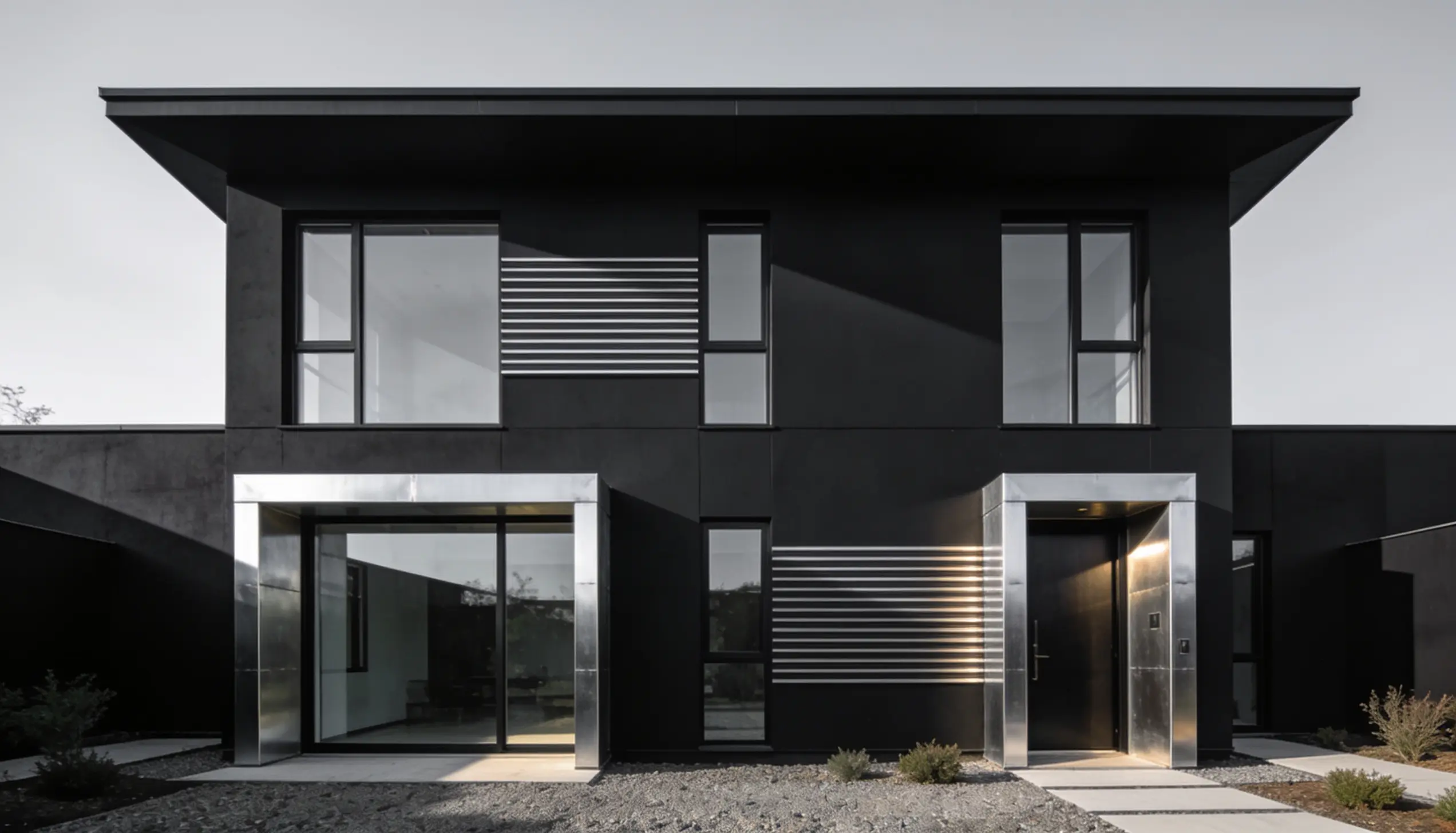 Modern black house with silver accents and large windows.