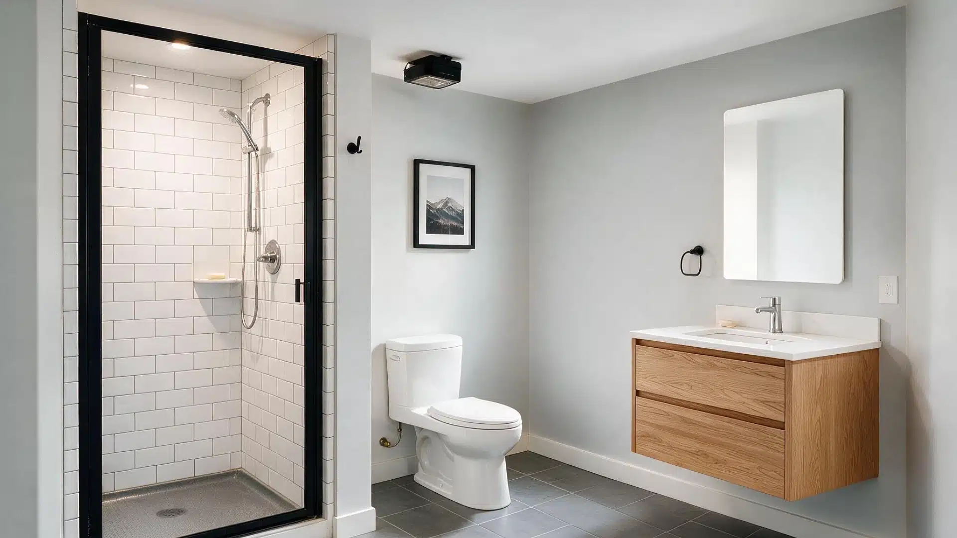 Compact basement bathroom with white tiled shower bathtub toilet vanity oval mirror and cool bright overhead lighting