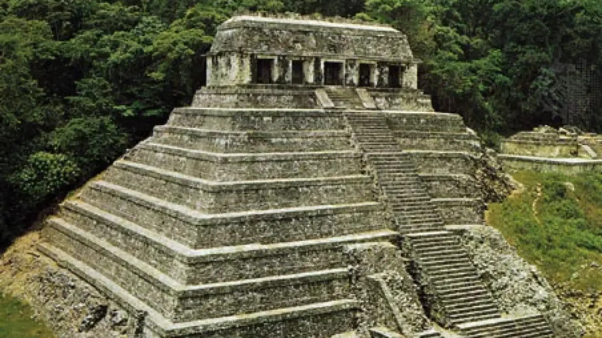 Aztec stepped pyramid surrounded by dense jungle altars and stone structures