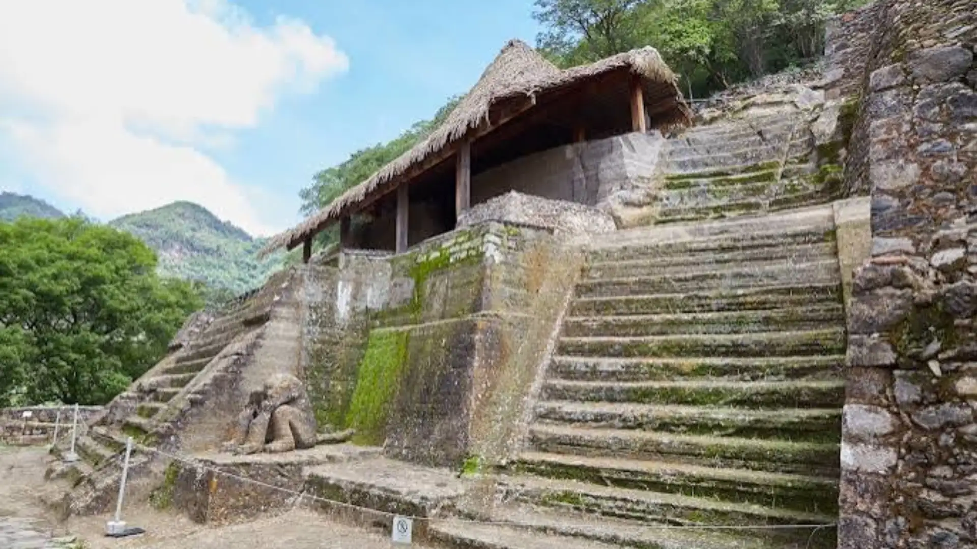 Malinalco archaeological site with ancient stone terraces and steps built into a green mountainside.
