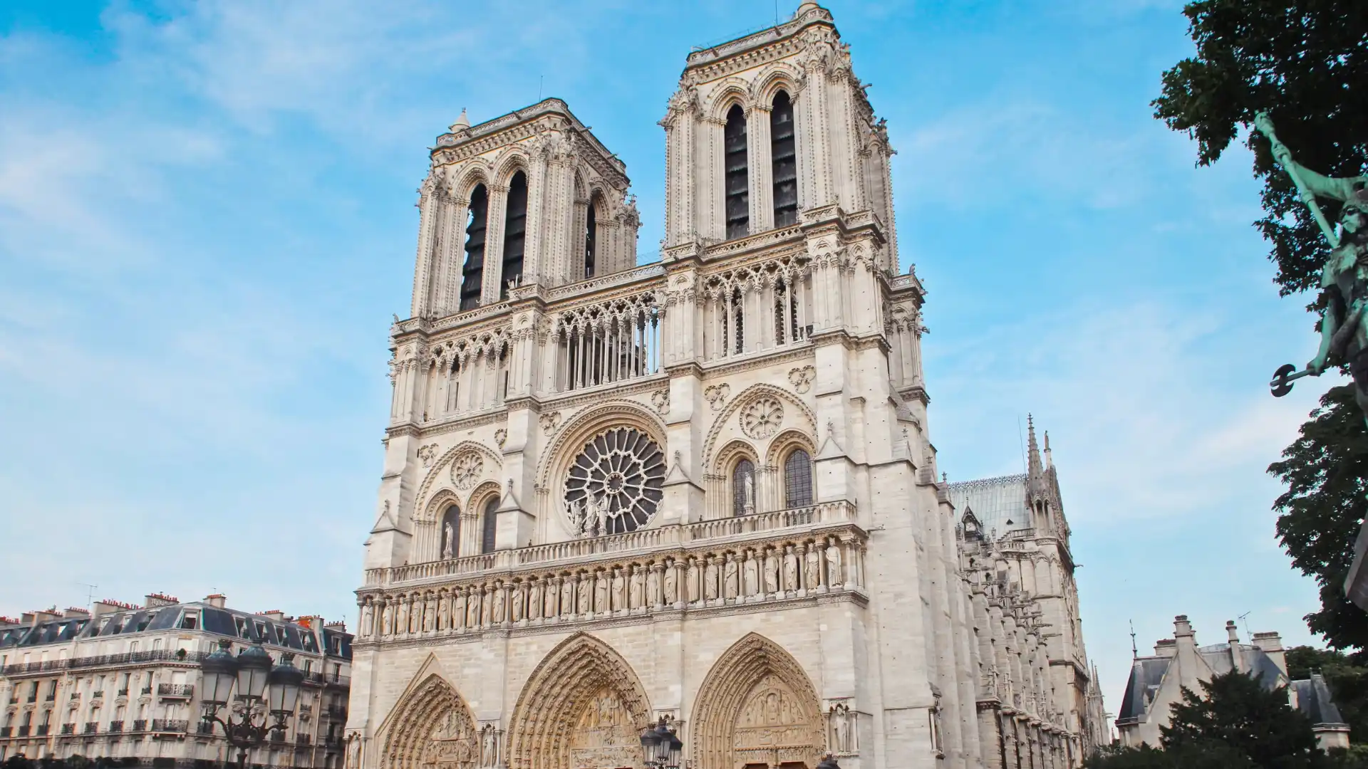Notre-Dame Cathedral in Paris, showcasing its Gothic façade, twin towers, ornate sculptures, and large rose window.
