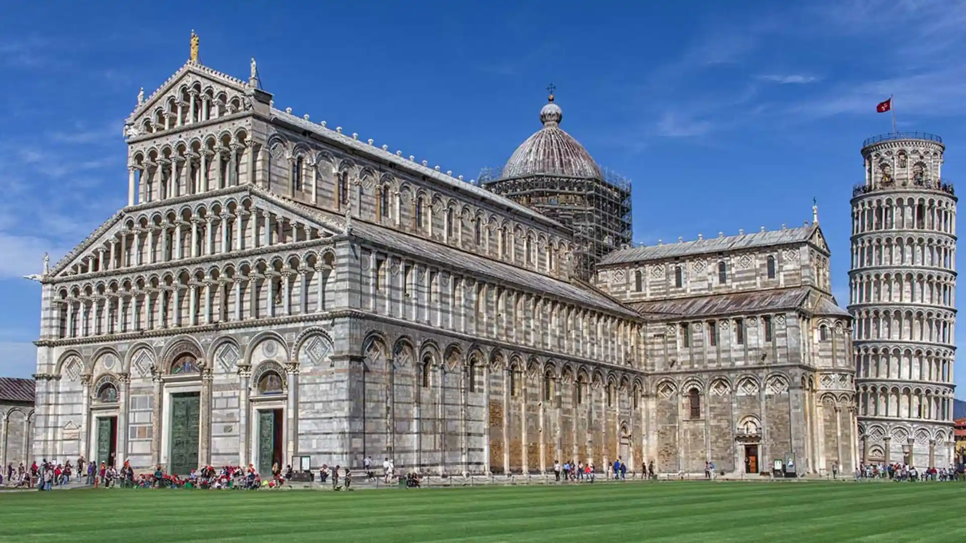 Romanesque cathedral with ornate arched façades and the Leaning Tower of Pisa beside it.