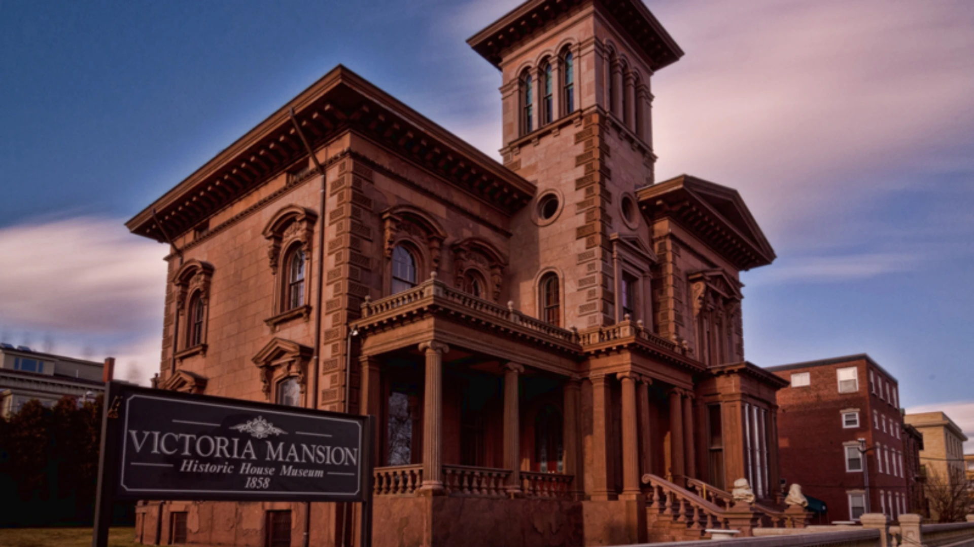 Victoria Mansion with ornate Italianate facade tall tower arched windows columned porch and decorative stone trim