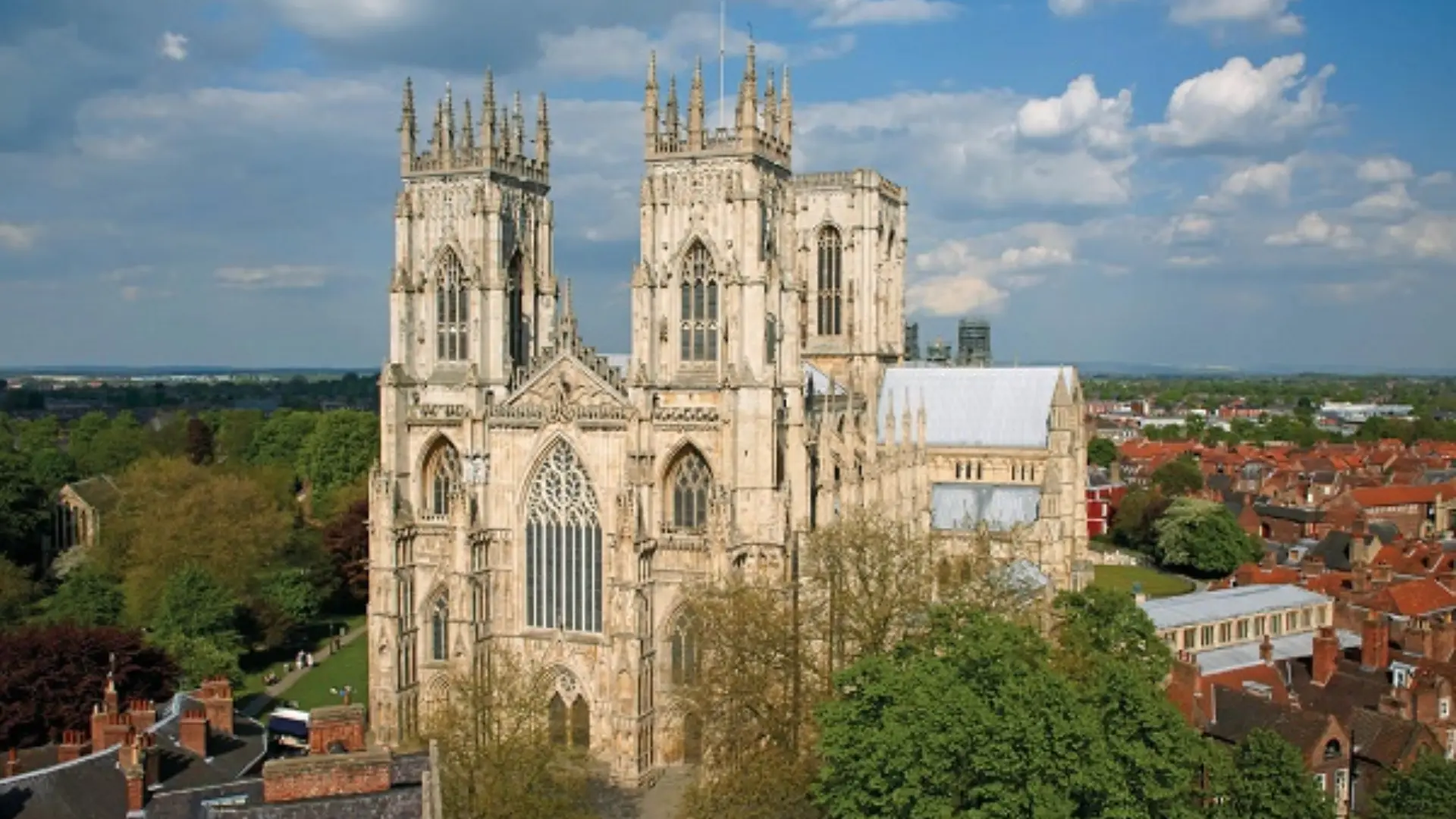 York Minster, a grand Gothic cathedral with ornate towers and large stained-glass windows overlooking the city of York.